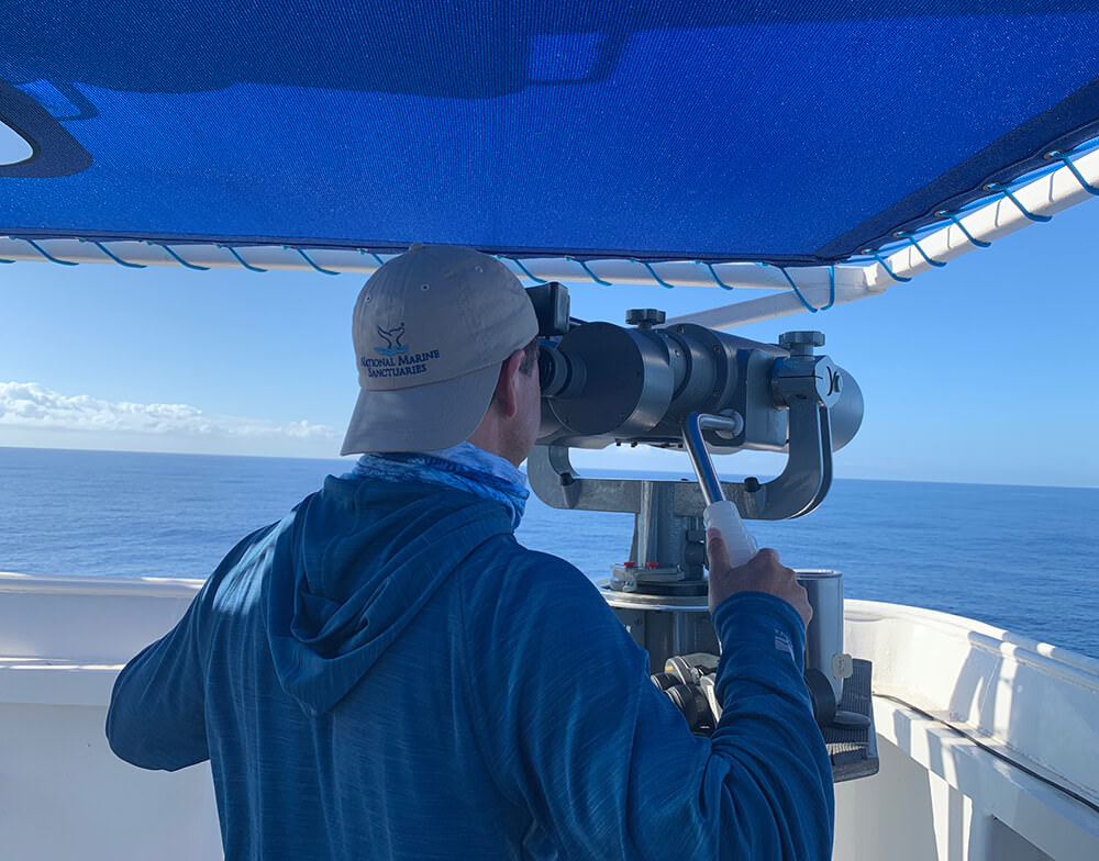 an image of a man looking through a telescope on a boat