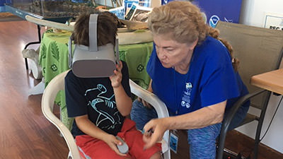 volunteer helping student with vr headset